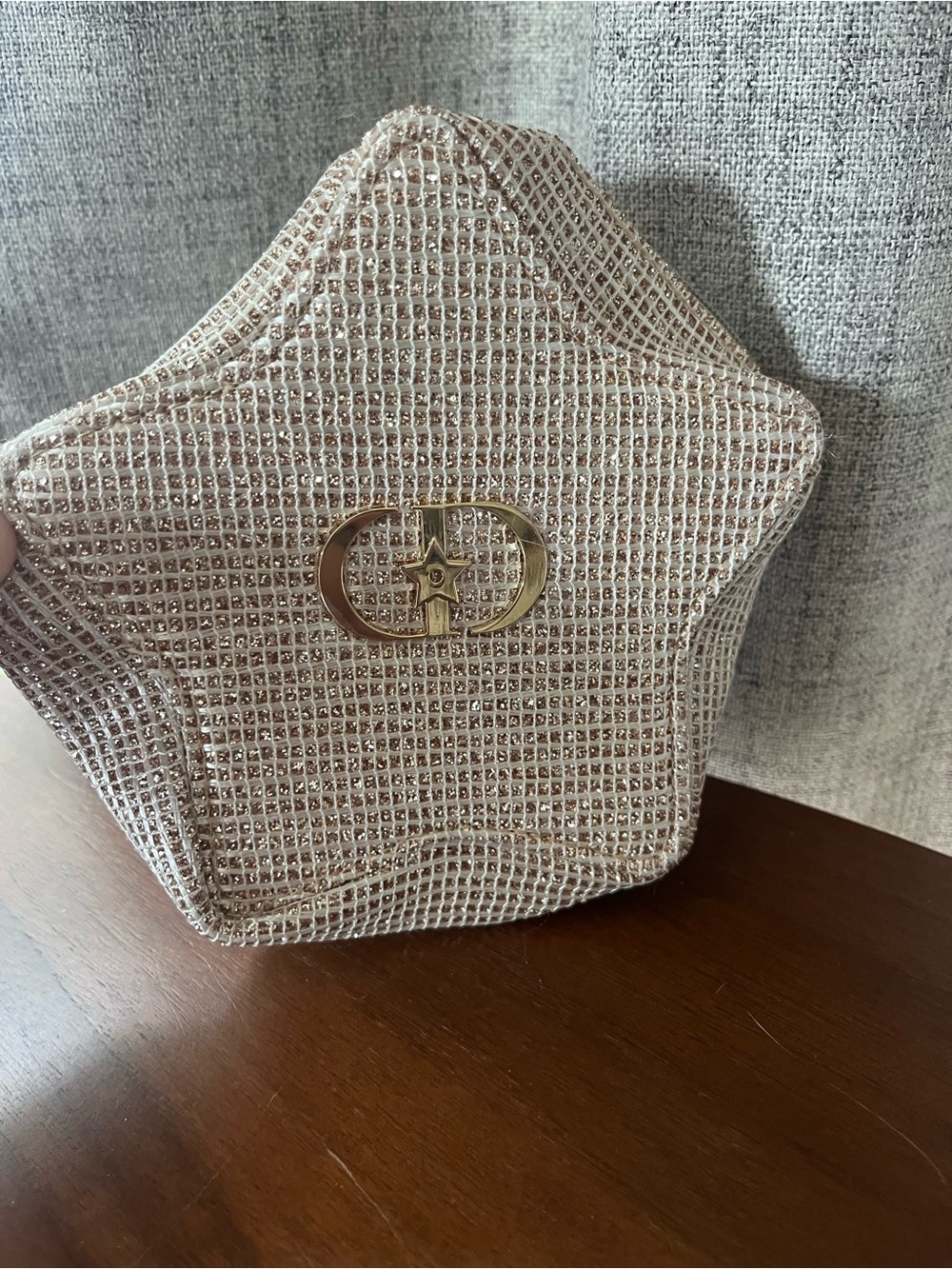 Dior Holiday 2025 Star Pouch is a textured, glittery gold makeup bag